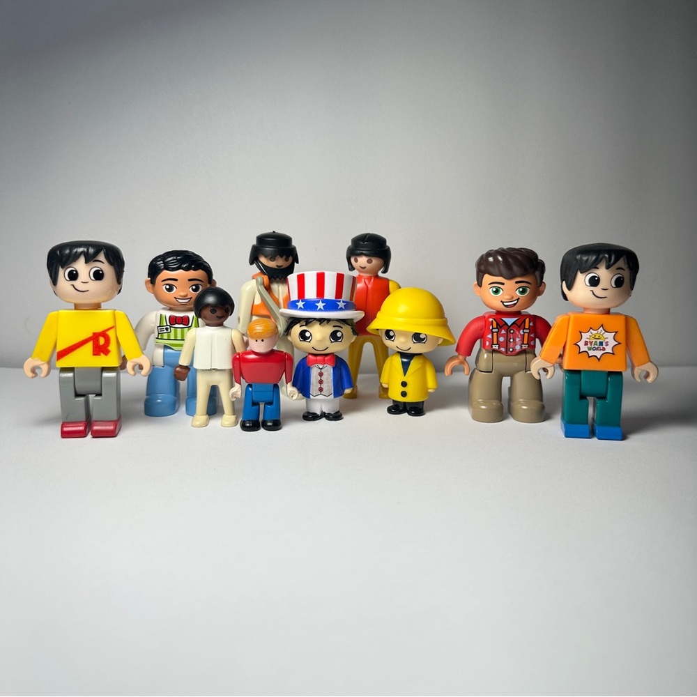 Diverse toy figures characters from Lego, tyco super blocks and Ryan’s world.